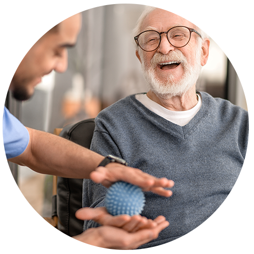 Man having his hand massaged with a spiky massage ball