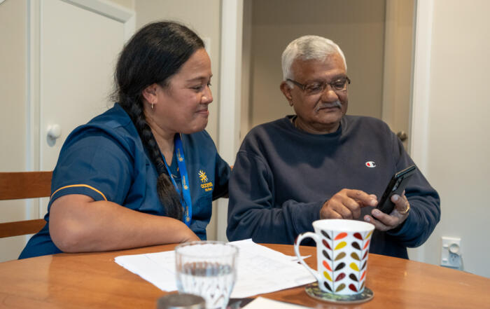 Lii and client at table with phone