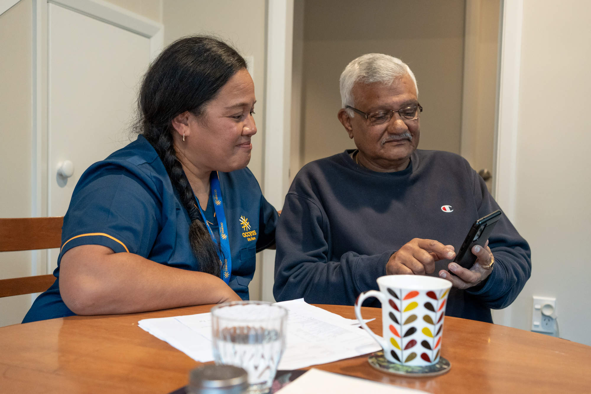 Lii and client at table with phone